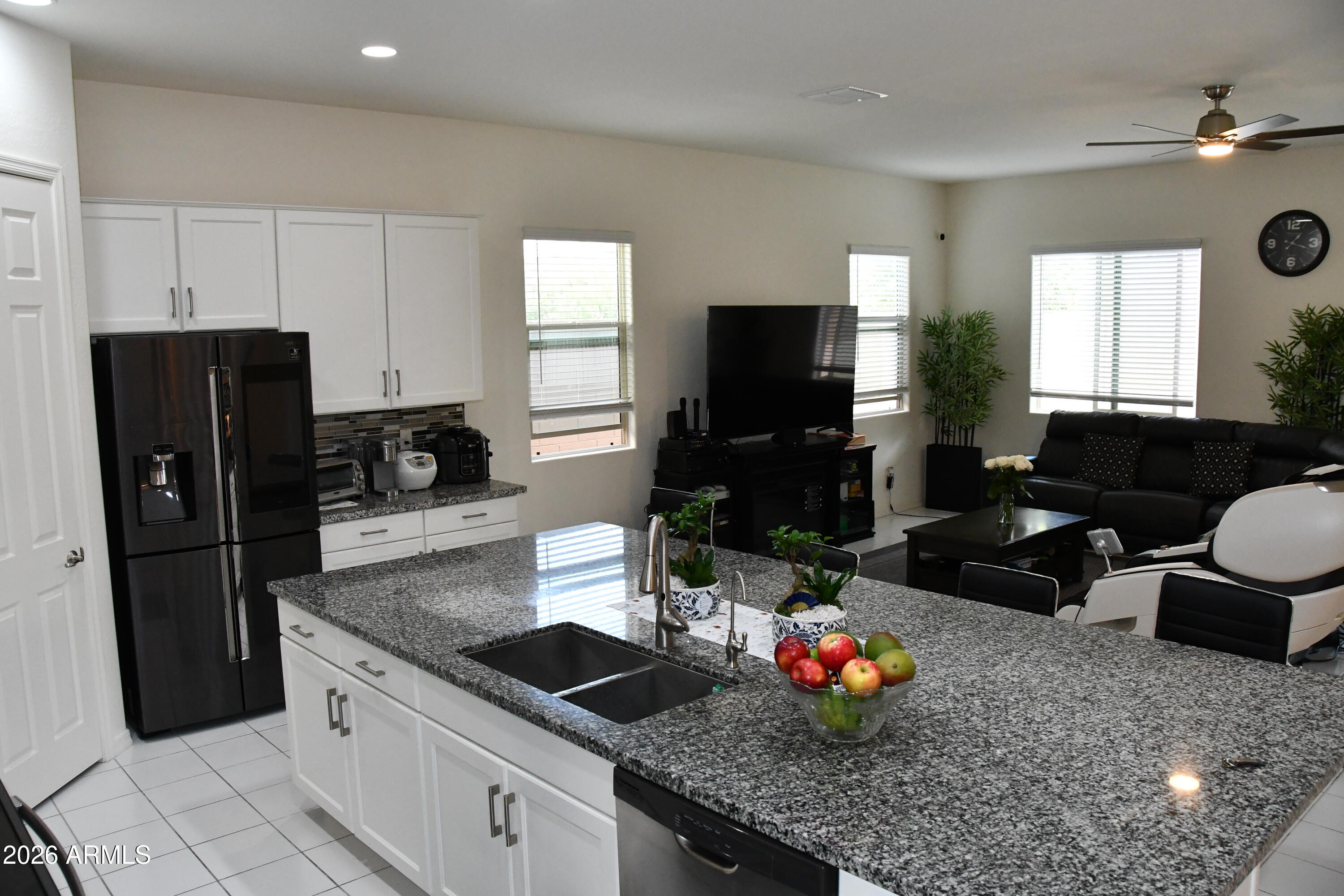 22419 97th Lane Peoria, AZ 85383 - Photo 3 of 22 a kitchen with granite countertop a sink dishwasher a refrigerator and a stove