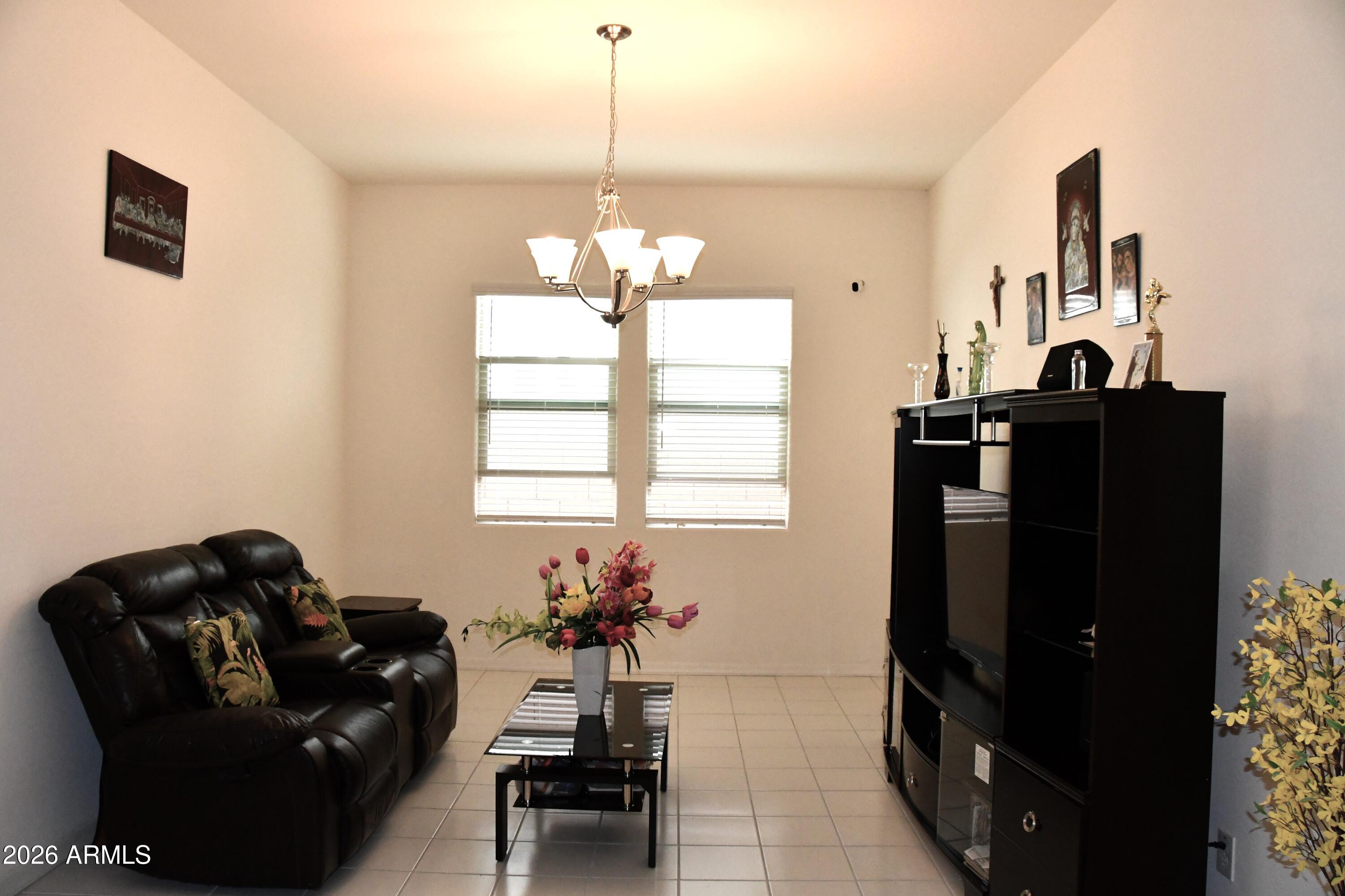 22419 97th Lane Peoria, AZ 85383 - Photo 9 of 22 a living room with furniture and a window