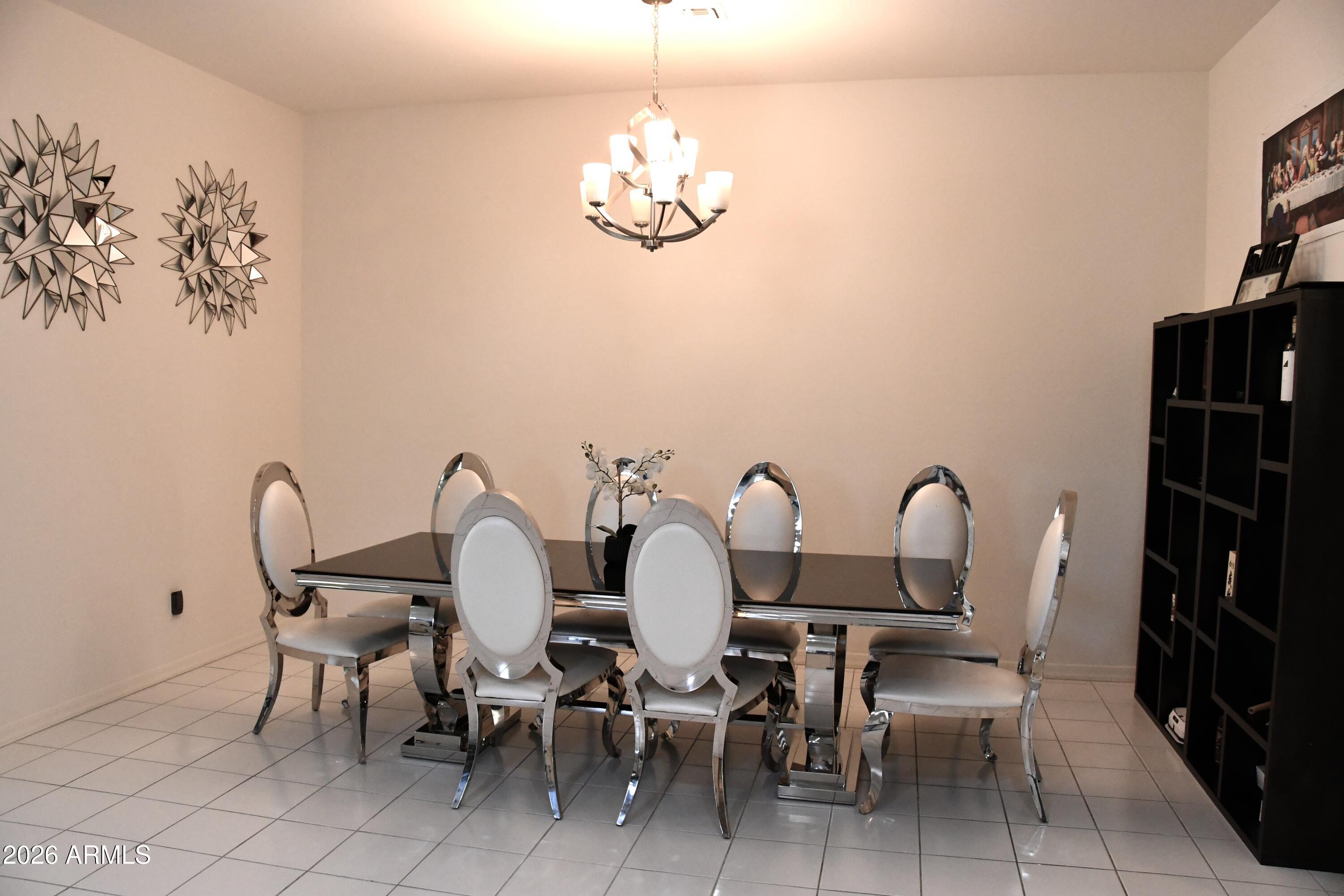 22419 97th Lane Peoria, AZ 85383 - Photo 10 of 22 a dining room with furniture and chandelier