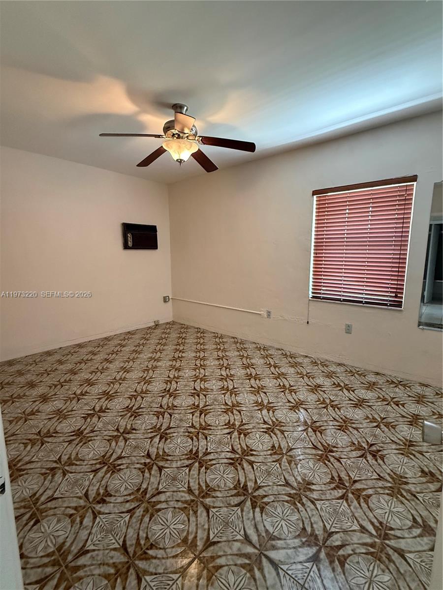 4255 Southwest 5th Terrace Miami, FL 33134 - Photo 12 of 29 a view of a livingroom with wooden floor and a ceiling fan