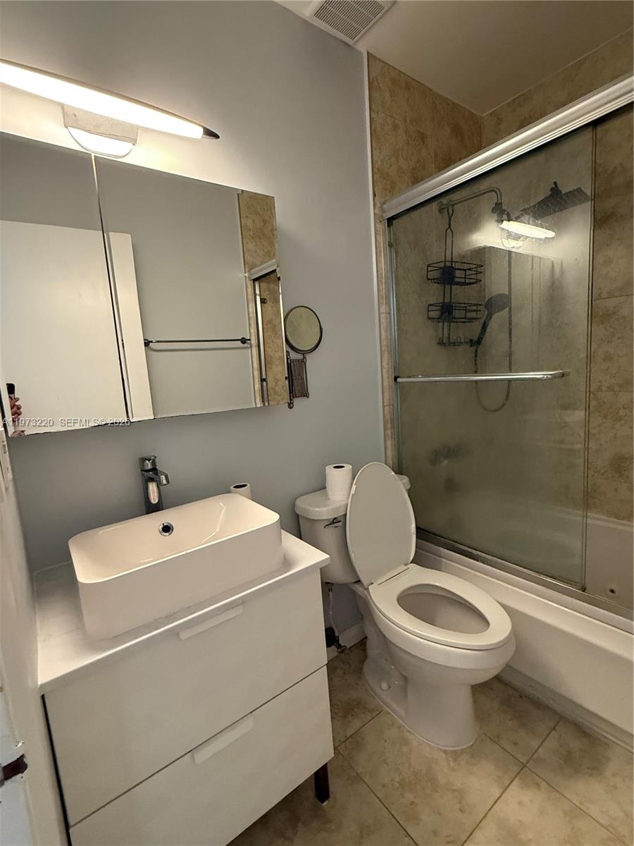 4255 Southwest 5th Terrace Miami, FL 33134 - Photo 14 of 29 a white toilet sitting next to a bathroom sink
