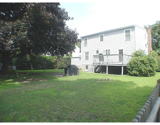 23 Virginia Road Arlington, MA 02476 - Photo 2 of 7 a backyard of a house with plants and large trees