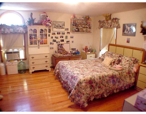 23 Virginia Road Arlington, MA 02476 - Photo 6 of 7 a large bed sitting in a bedroom next to a cabinet