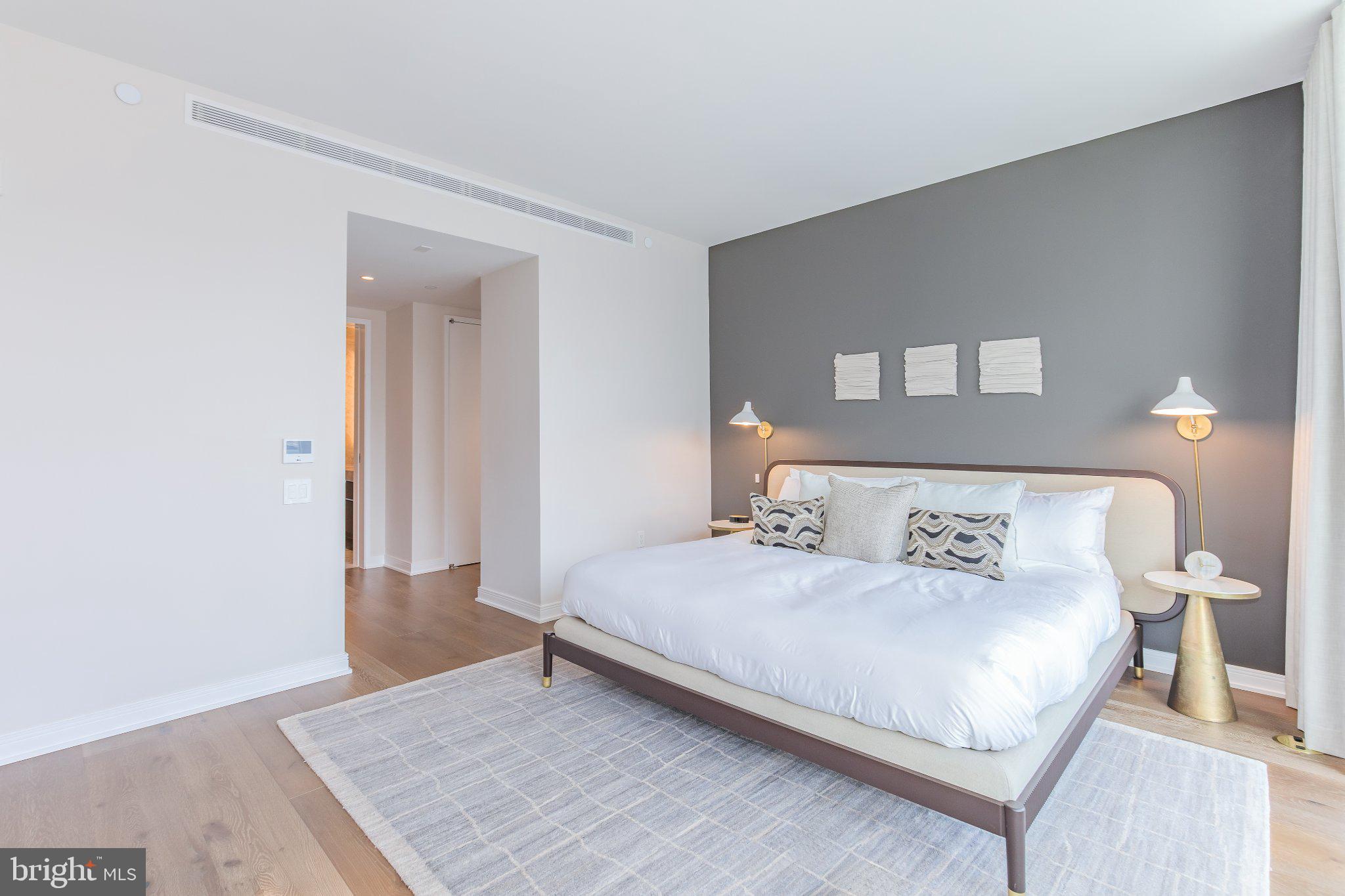 601 Wharf Street Southwest, Unit 203 Washington, DC 20024 - Photo 11 of 34 a bedroom with a bed and a table