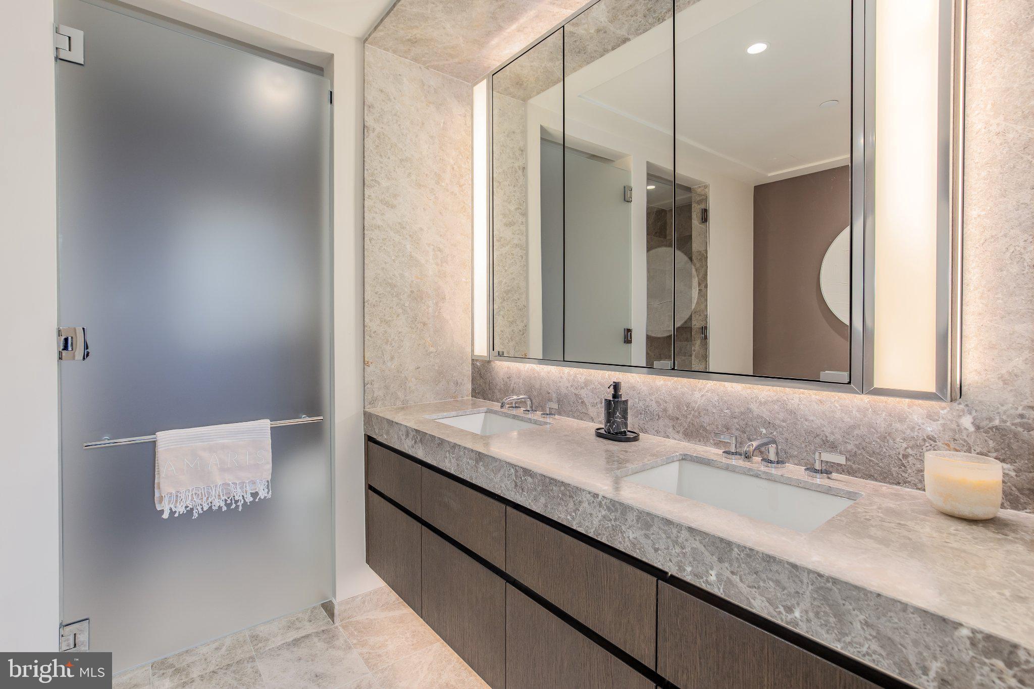 601 Wharf Street Southwest, Unit 203 Washington, DC 20024 - Photo 13 of 34 a bathroom with a granite countertop sink and a mirror