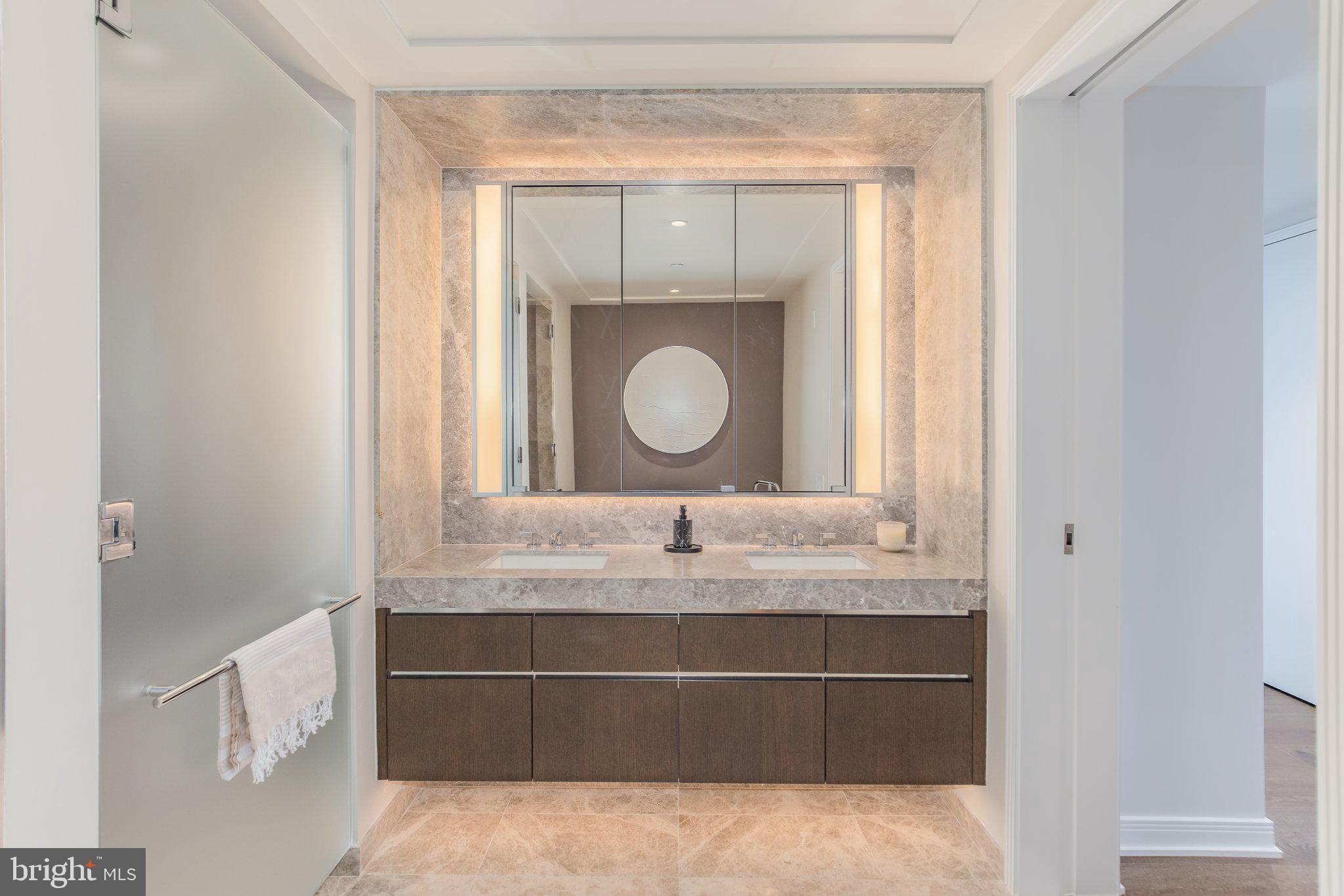 601 Wharf Street Southwest, Unit 203 Washington, DC 20024 - Photo 14 of 34 a bathroom with a granite countertop sink a mirror and a vanity