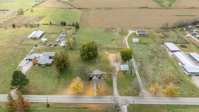 an aerial view of a house with a yard