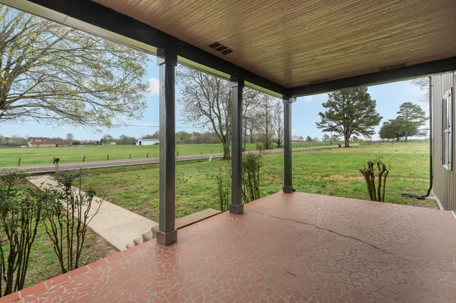 a kitchen with granite countertop a stove sink and cabinets