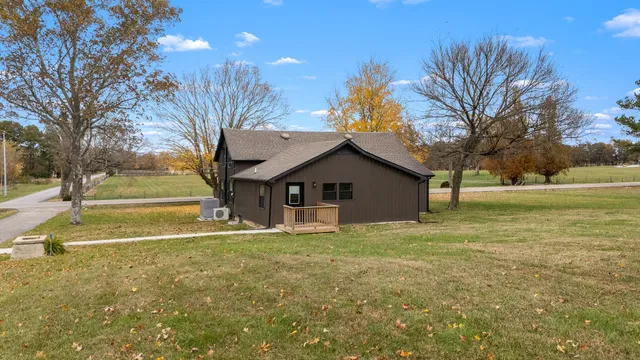 a view of a house with backyard and tree
