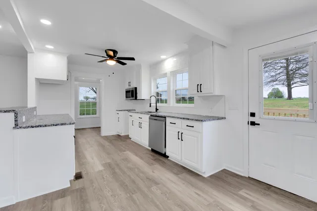 a kitchen with stainless steel appliances granite countertop a stove and a sink