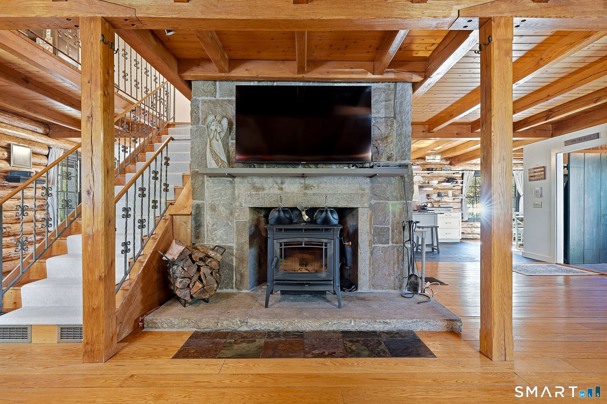 61 Mystic Road North Stonington, CT 06359 - Photo 6 of 40 a living room with a fireplace and a flat screen tv