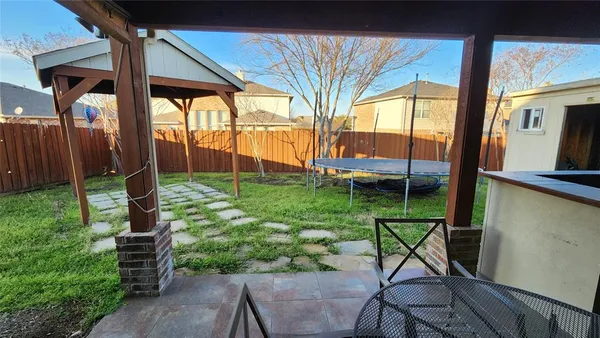 a view of a chair and table in backyard