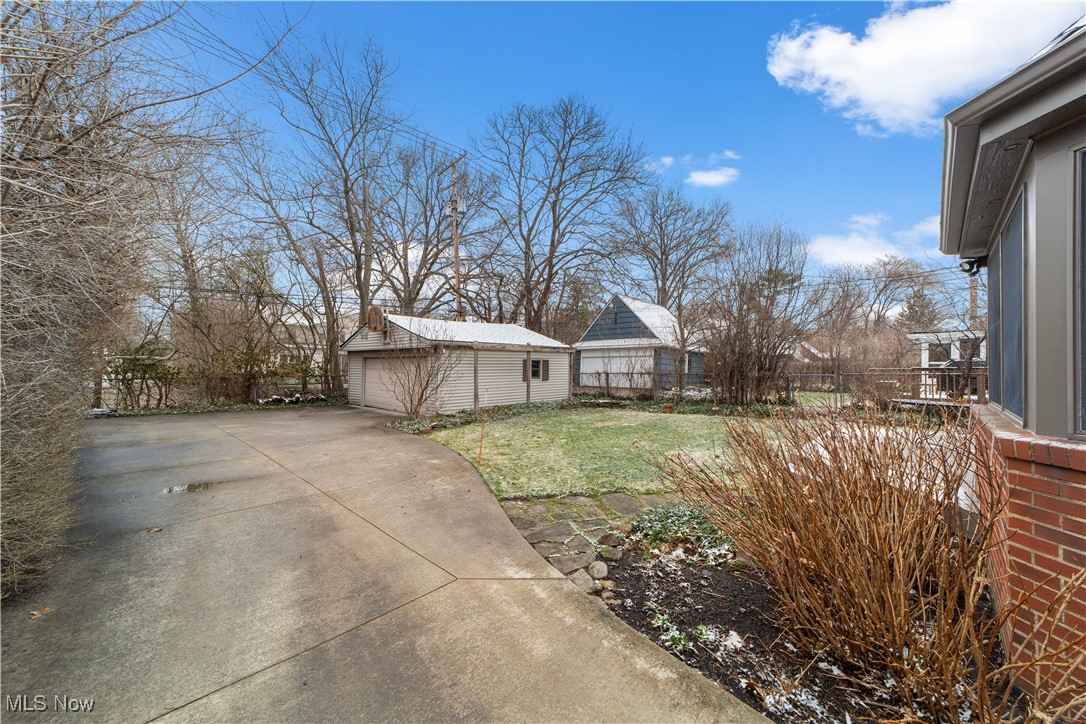 17027 Fernway Road Cleveland, OH 44120 - Photo 34 of 42 View of yard with an outbuilding, driveway, a detached garage, and fence