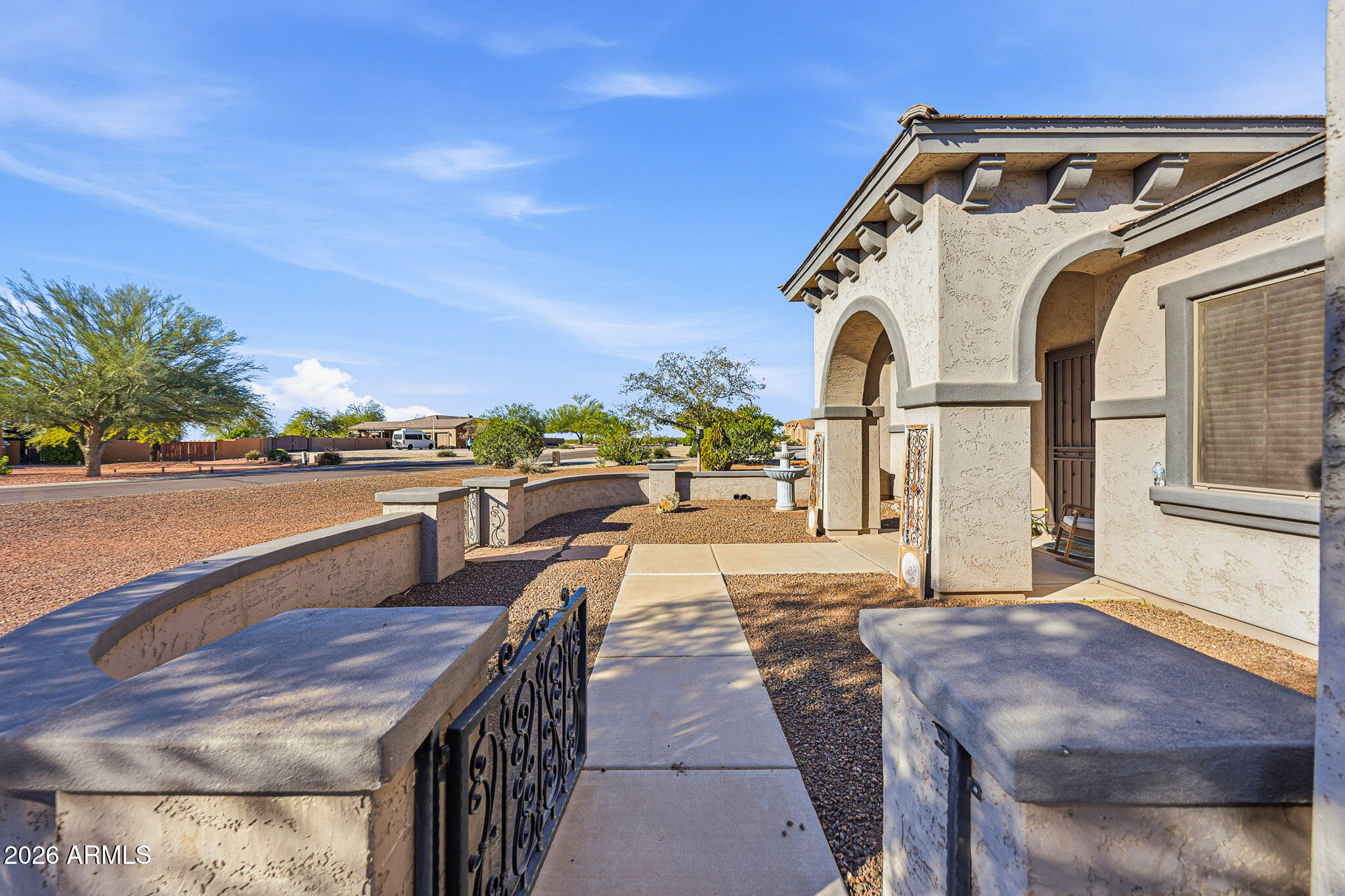 23024 West Sierra Ridge Way Wittmann, AZ 85361 - Photo 7 of 99 a view of a patio with a table and chairs