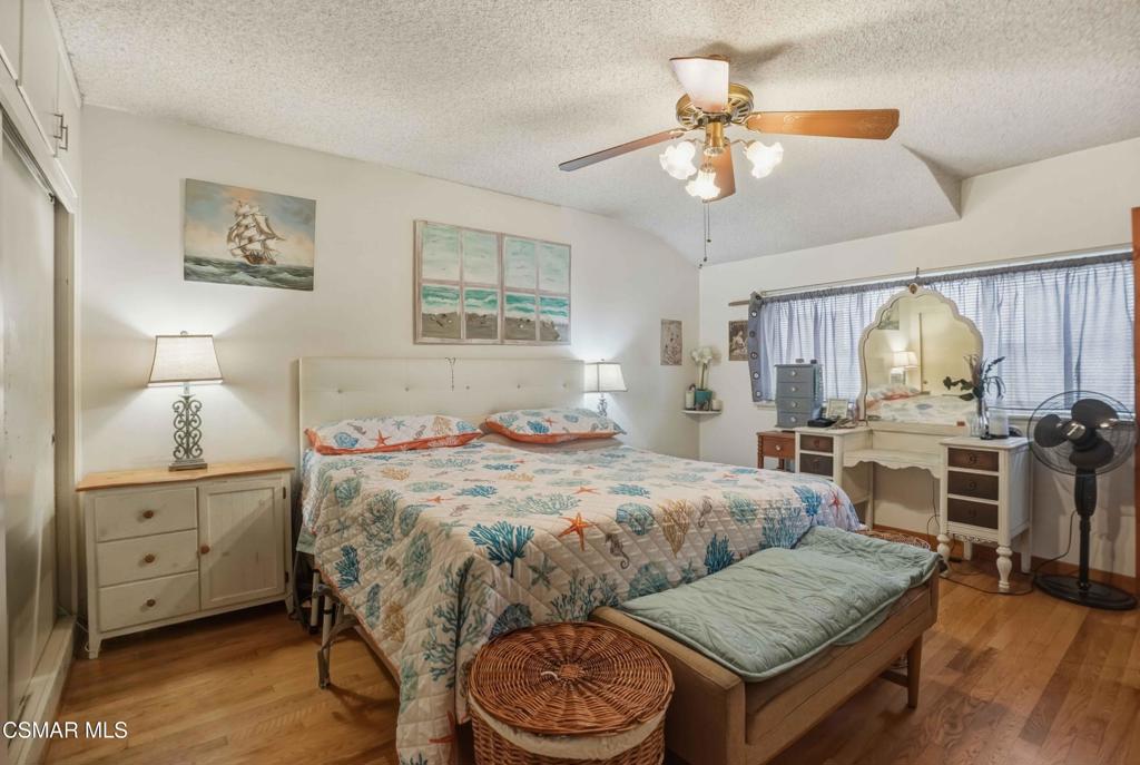 558 East Hemlock Street Oxnard, CA 93033 - Photo 13 of 22 a bedroom with a bed and a chandelier