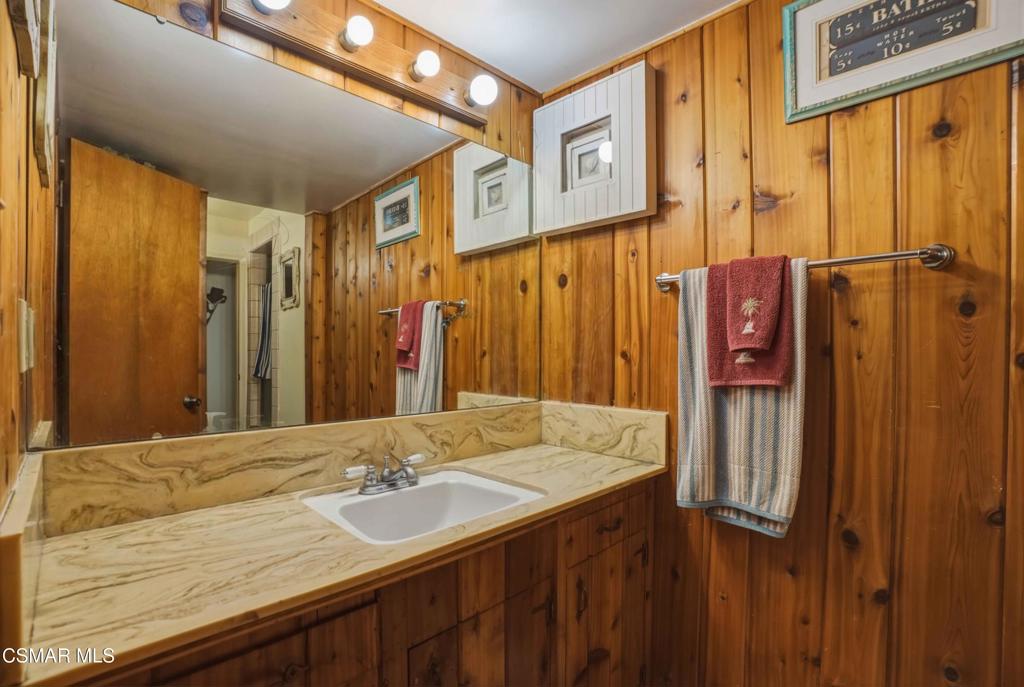 558 East Hemlock Street Oxnard, CA 93033 - Photo 15 of 22 a bathroom with a double vanity sink and a mirror