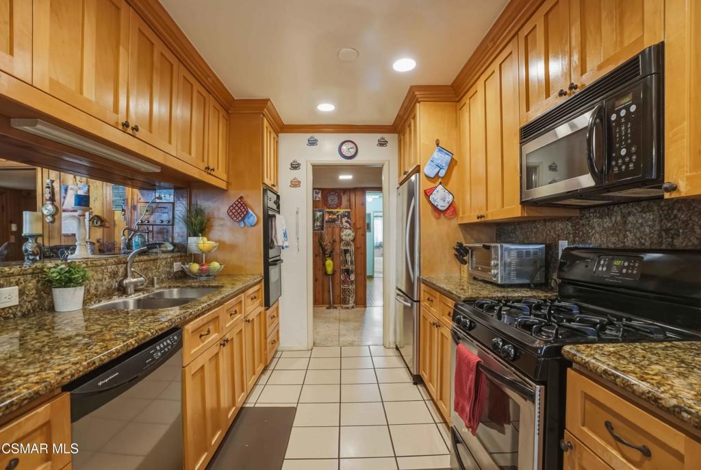 558 East Hemlock Street Oxnard, CA 93033 - Photo 2 of 22 a kitchen with stainless steel appliances granite countertop a stove and a sink