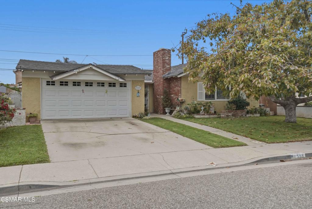 558 East Hemlock Street Oxnard, CA 93033 - Photo 22 of 22 a front view of a house with a yard and garage
