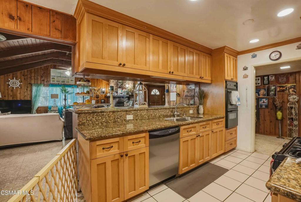 558 East Hemlock Street Oxnard, CA 93033 - Photo 3 of 22 a kitchen with stainless steel appliances granite countertop a sink and cabinets