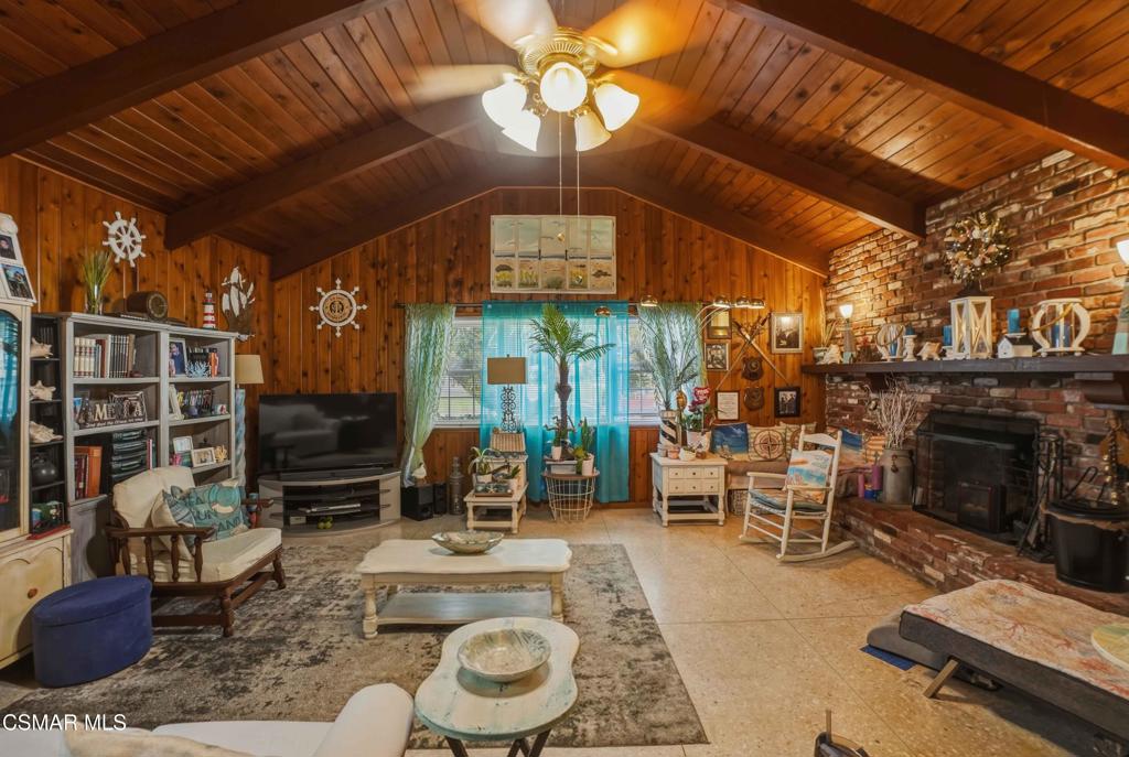558 East Hemlock Street Oxnard, CA 93033 - Photo 4 of 22 a living room with furniture a fireplace and a chandelier