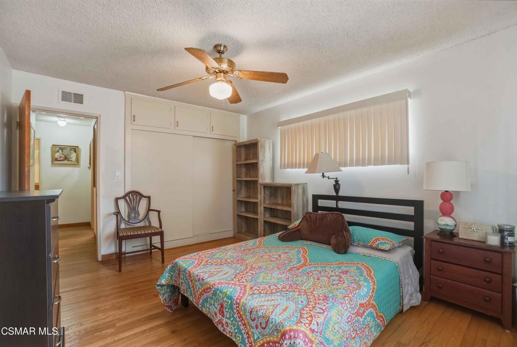 558 East Hemlock Street Oxnard, CA 93033 - Photo 8 of 22 a bedroom with a bed and wooden floor