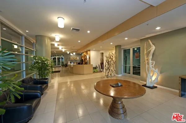 a view of a lobby with table and chairs