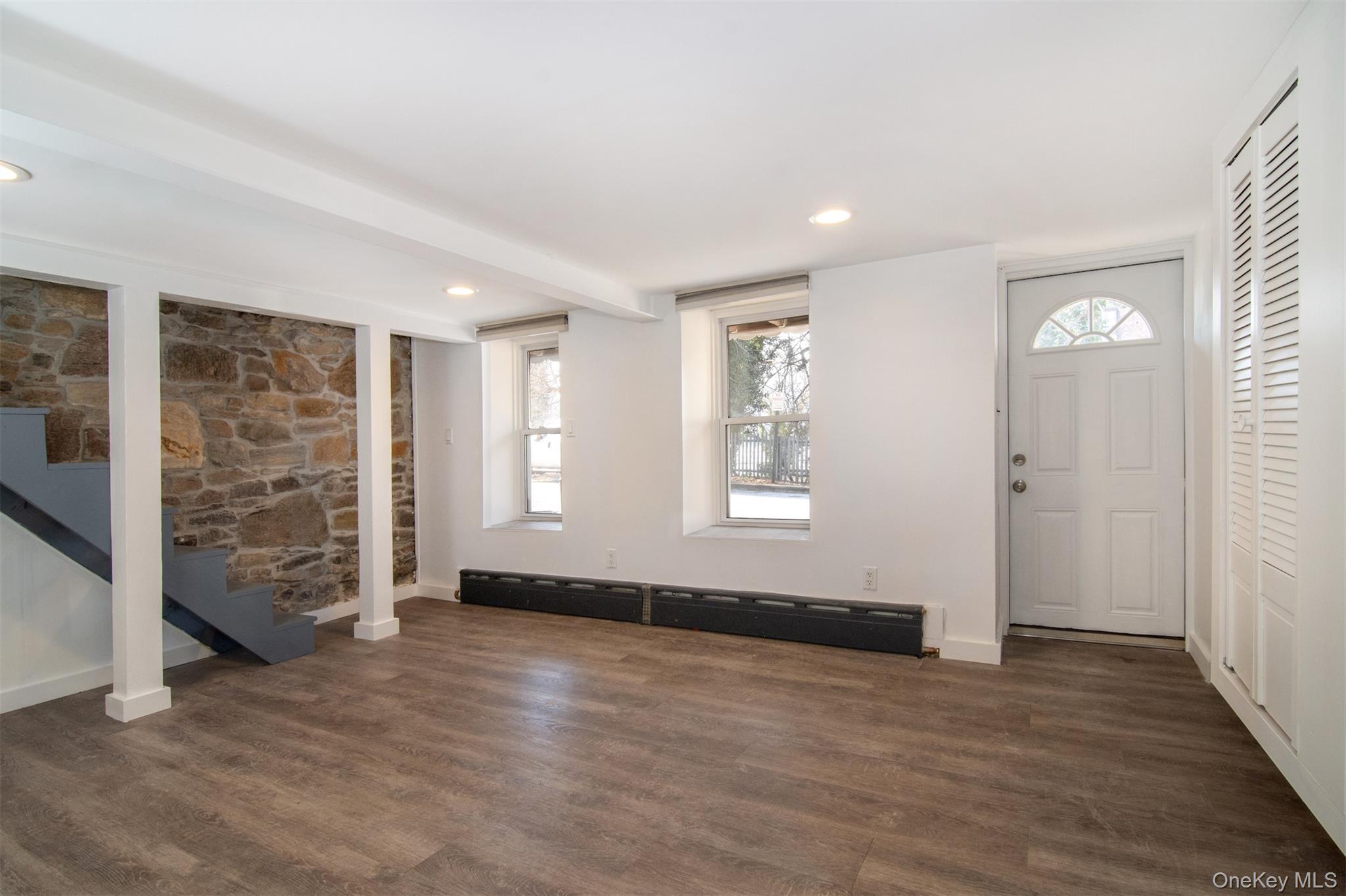44 Ridge Street, Unit 1 Hastings-on-Hudson, NY 10706 - Photo 11 of 16 Walkout Lower level featuring baseboard heating and dark hardwood / wood-style floors