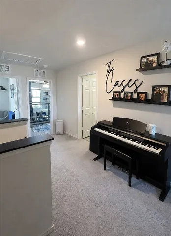 a living room with furniture and a pool table