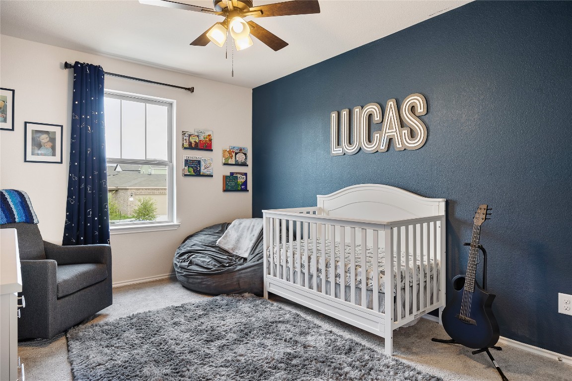 104 Hellfighters Way Jarrell, TX 76537 - Photo 18 of 27 a bedroom with a bed and a couch