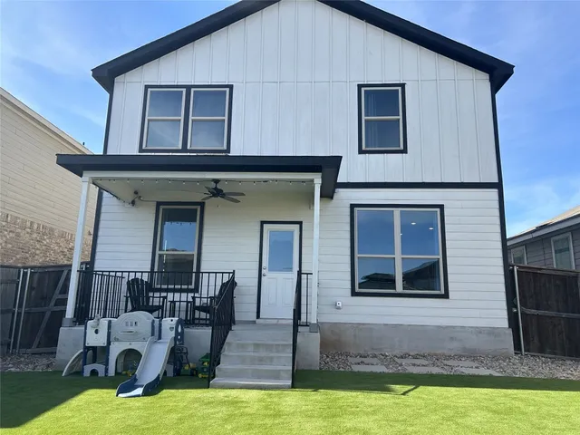 a view of a house with yard and sitting area