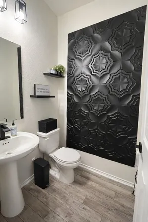 a bathroom with a toilet sink and mirror