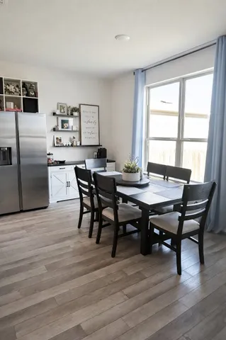 a view of a dining room with furniture window and wooden floor
