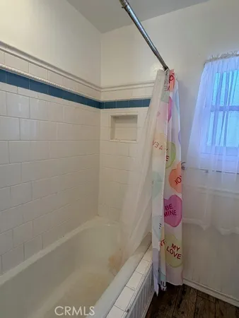 a bathroom with a toilet and a mirror