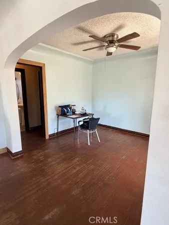 a view of a workspace with furniture and wooden floor