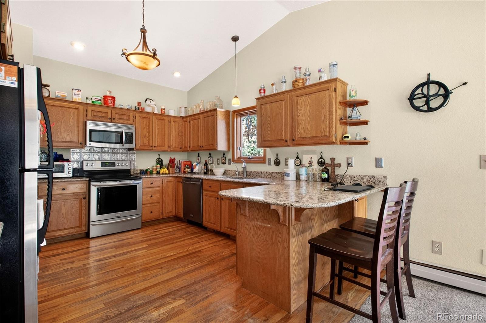 1445 Sutherland Road Manitou Springs, CO 80829 - Photo 15 of 43 a kitchen with granite countertop a sink appliances and cabinets