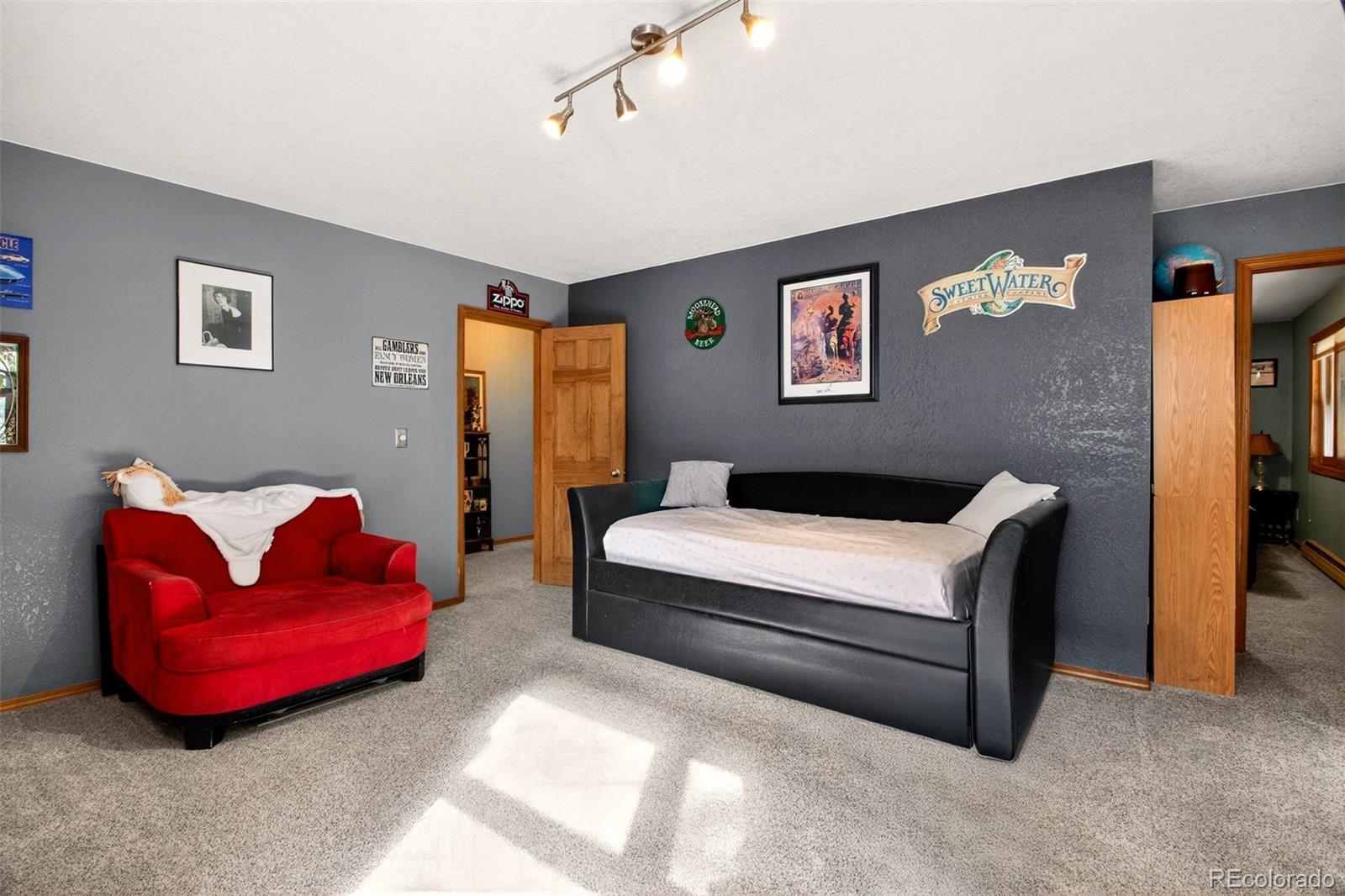 1445 Sutherland Road Manitou Springs, CO 80829 - Photo 31 of 43 a spacious bedroom with a bed and a couch