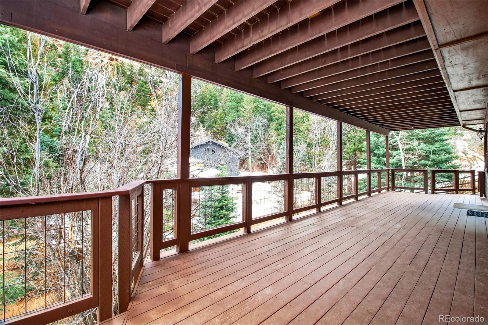 1445 Sutherland Road Manitou Springs, CO 80829 - Photo 35 of 43 a porch with wooden floors in outdoor space