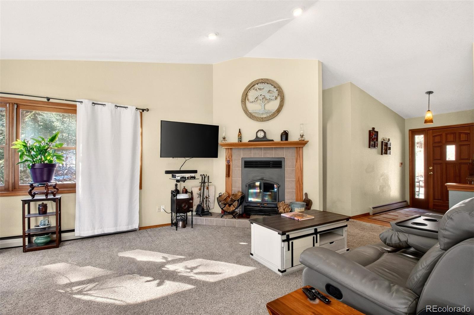 1445 Sutherland Road Manitou Springs, CO 80829 - Photo 6 of 43 a living room with furniture a window and a flat screen tv