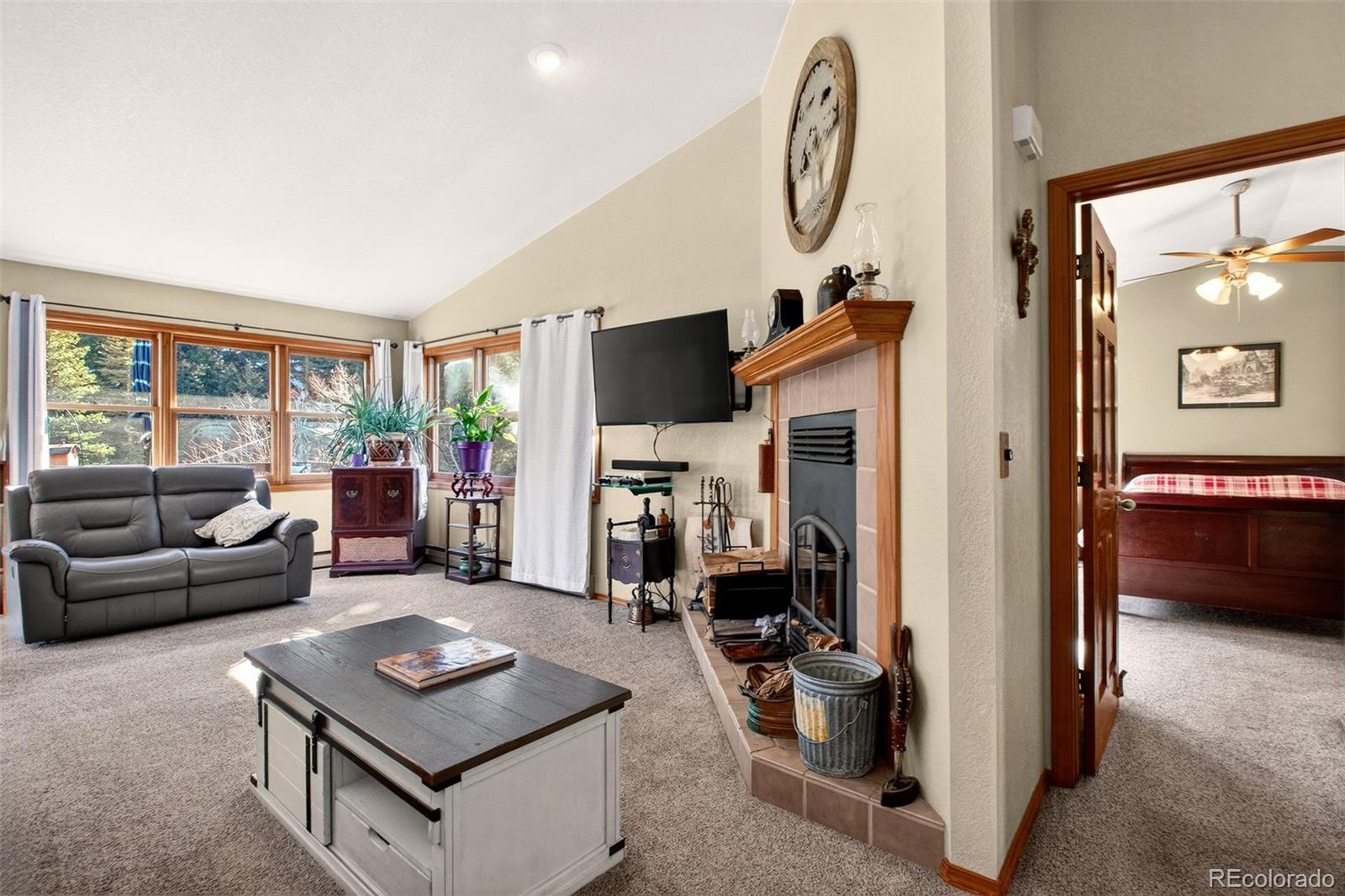 1445 Sutherland Road Manitou Springs, CO 80829 - Photo 8 of 43 a living room with furniture and a large window