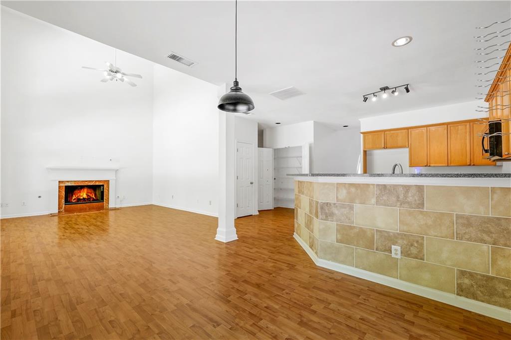 873 Red Rock Court Suwanee, GA 30024 - Photo 15 of 36 a view of empty room with wooden floor and fan