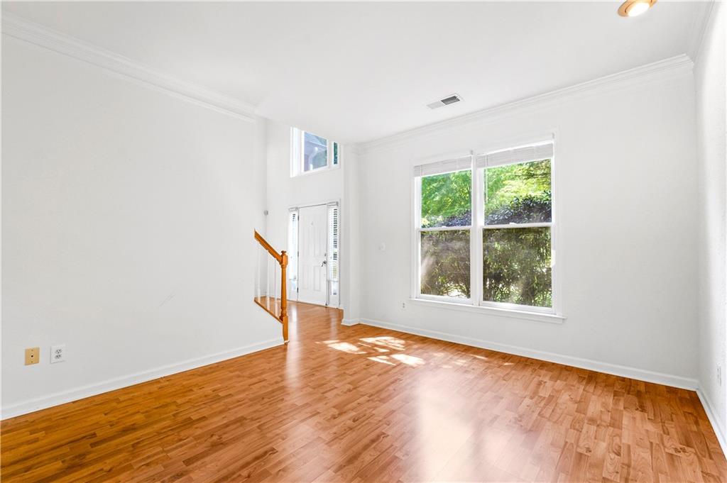 873 Red Rock Court Suwanee, GA 30024 - Photo 16 of 36 an empty room with wooden floor and windows