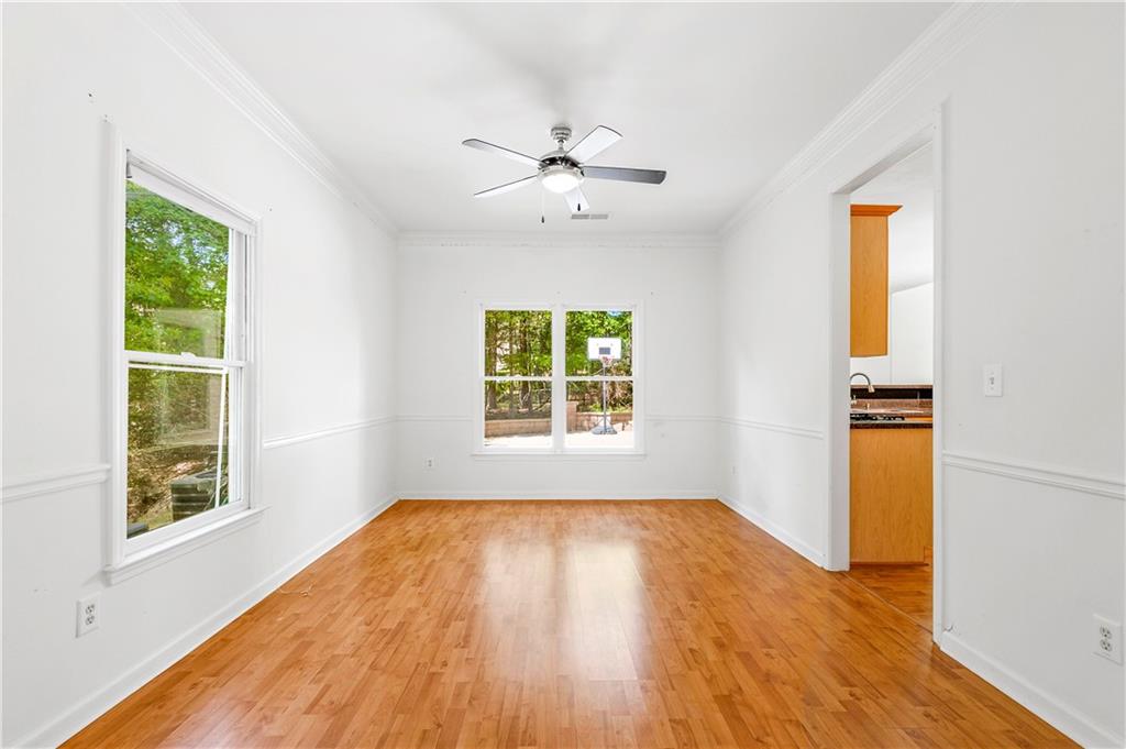 873 Red Rock Court Suwanee, GA 30024 - Photo 17 of 36 wooden floor in an empty room with a window