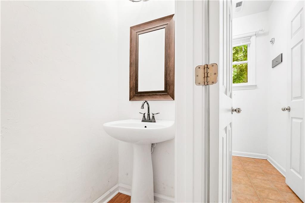 873 Red Rock Court Suwanee, GA 30024 - Photo 19 of 36 a bathroom with a sink a mirror and a window