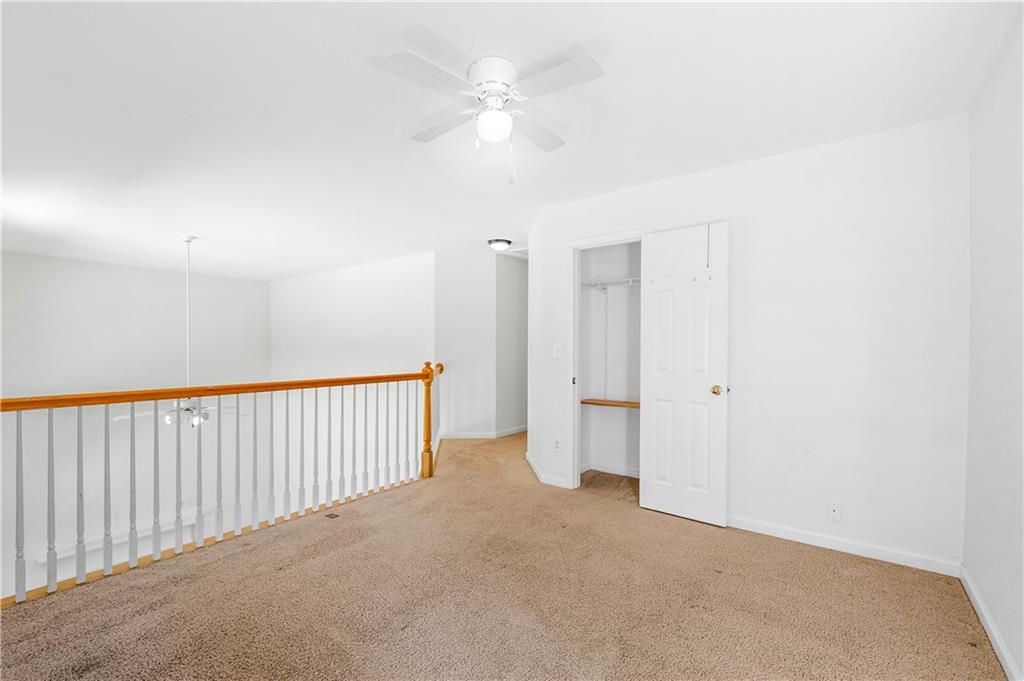 873 Red Rock Court Suwanee, GA 30024 - Photo 20 of 36 a view of a livingroom with a ceiling fan & entryway