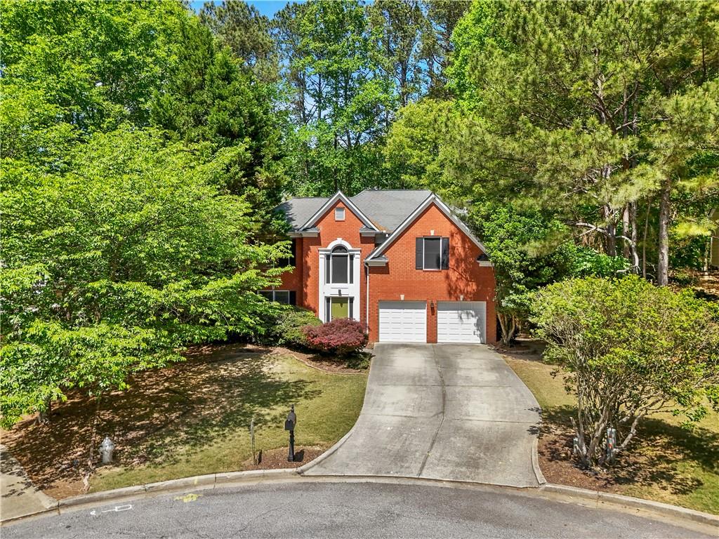 873 Red Rock Court Suwanee, GA 30024 - Photo 2 of 36 front view of a house with a yard