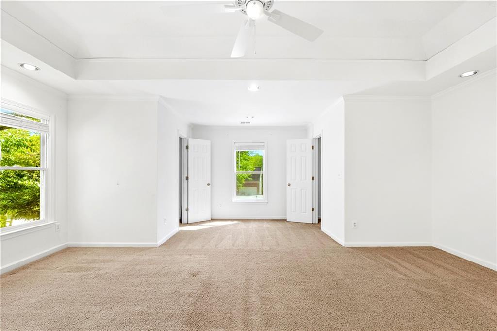 873 Red Rock Court Suwanee, GA 30024 - Photo 22 of 36 a view of a room with a window and a ceiling fan