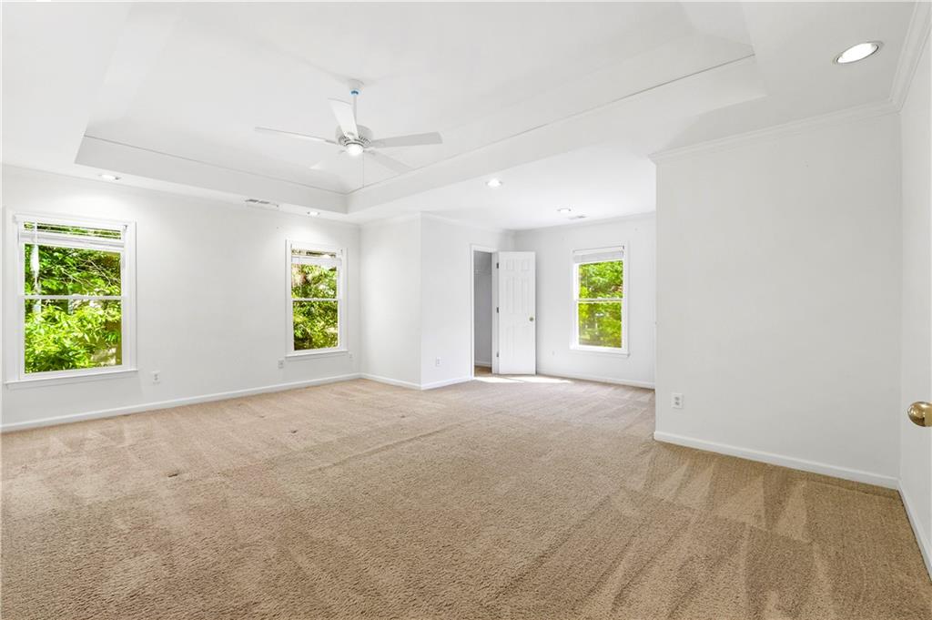 873 Red Rock Court Suwanee, GA 30024 - Photo 23 of 36 an empty room with windows and a ceiling fan