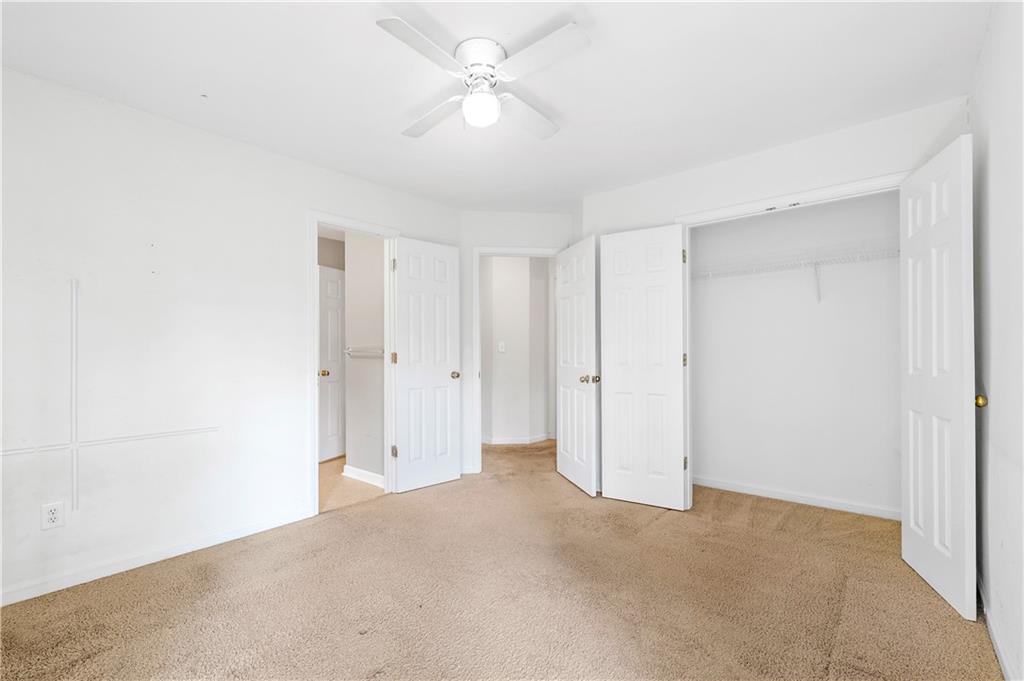 873 Red Rock Court Suwanee, GA 30024 - Photo 30 of 36 a view of a big room with carpet