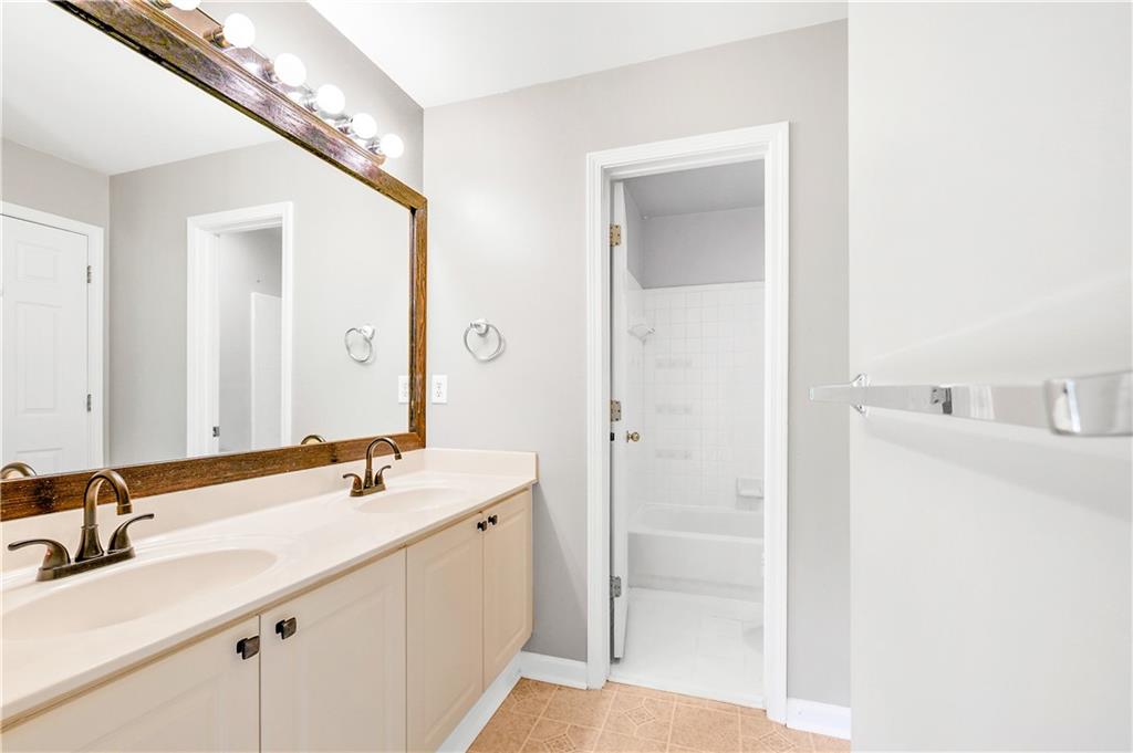 873 Red Rock Court Suwanee, GA 30024 - Photo 35 of 36 a bathroom with a sink and a mirror