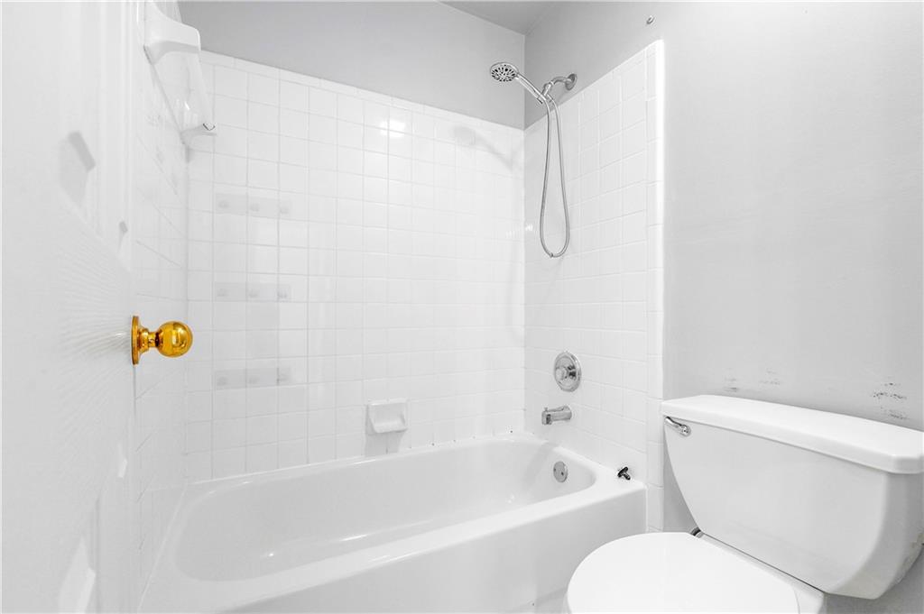 873 Red Rock Court Suwanee, GA 30024 - Photo 36 of 36 a bathroom with a sink a toilet and a bathtub